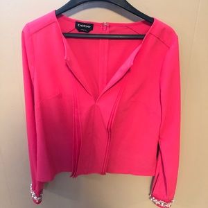 Bright pink long sleeve top.